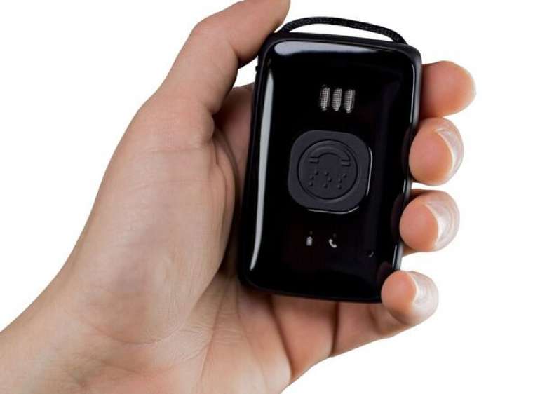 A hand holding a Belle carelink device