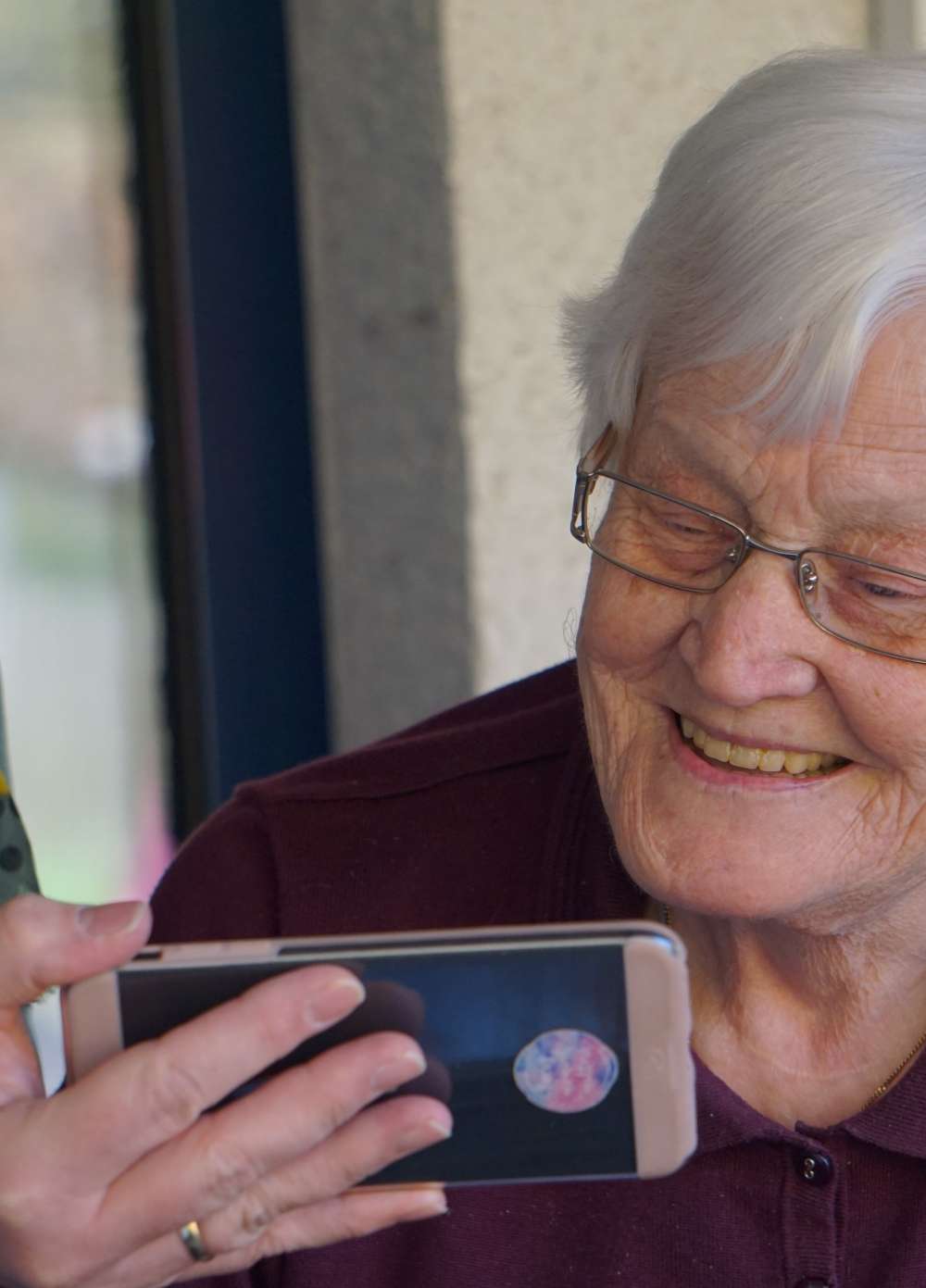 Elderly woman looking at a mobile phone