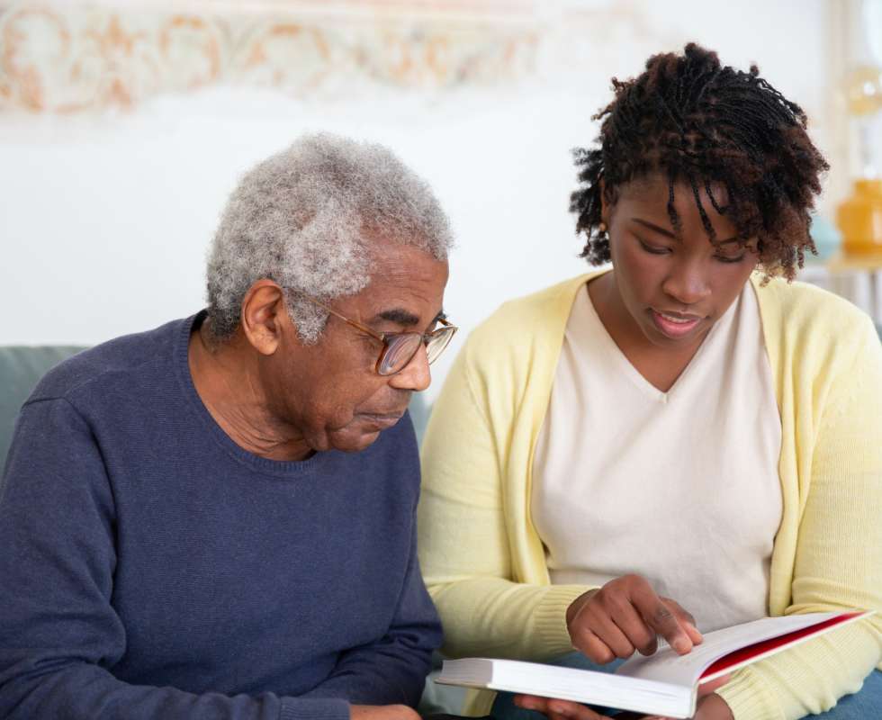 Photo for Two adults looking at a book